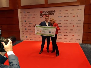 Ian with Sarah Beeny with the #IanClimbsKMJ flag at the Roofing Awards
